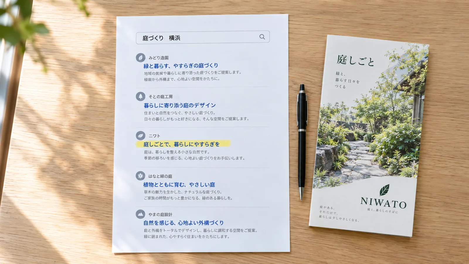 打ち合わせ机の上に置かれた、検索結果のページを印刷した紙。自社のページの行だけが黄色の蛍光ペンで引かれ、横に同じ会社のパンフレットがある